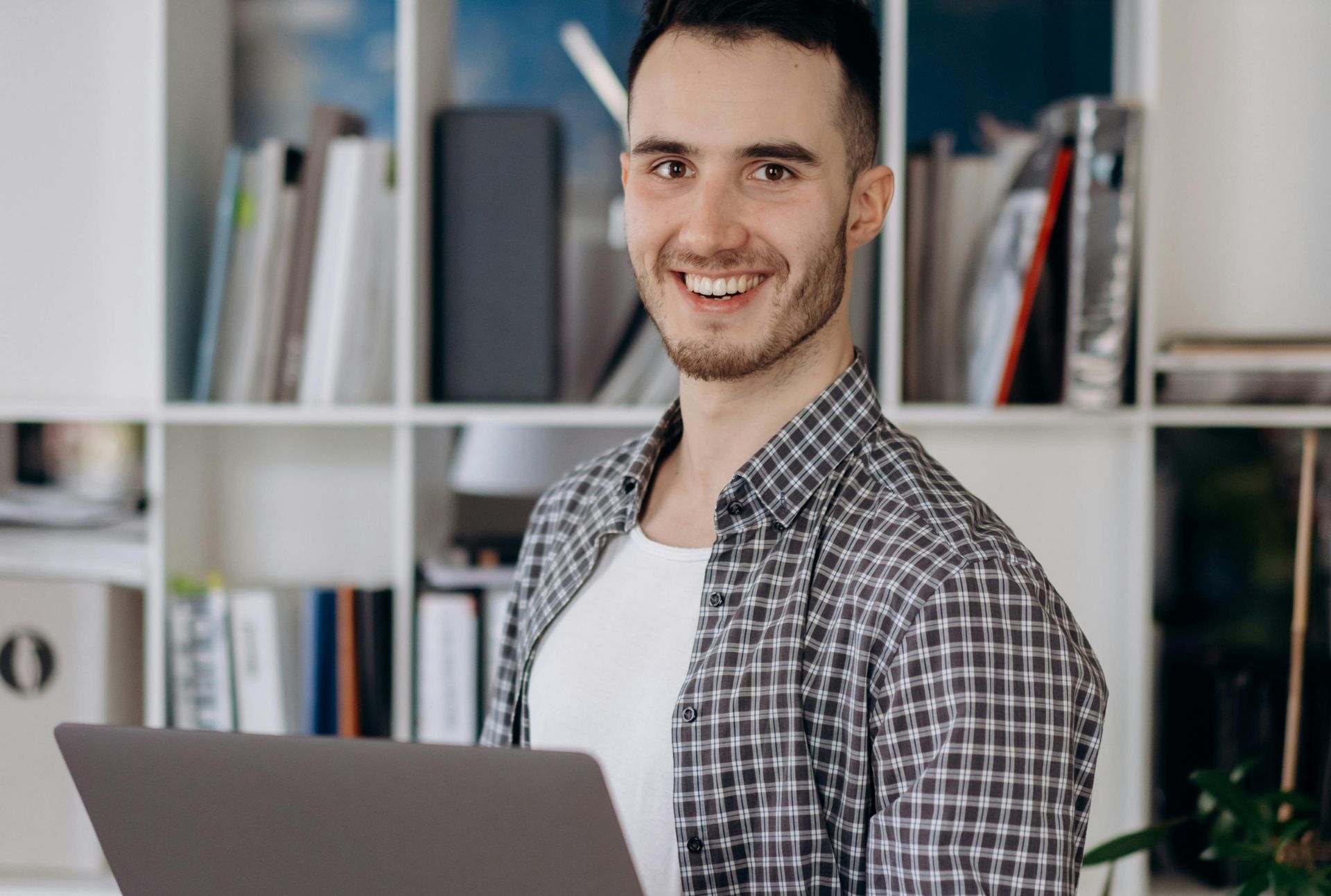 Young European man working as an outsourced software developer, illustrating staff outsourcing services, cost savings, and reduced operational costs. Highlighting the role of outsourced employees and external service providers in effective business strategy.