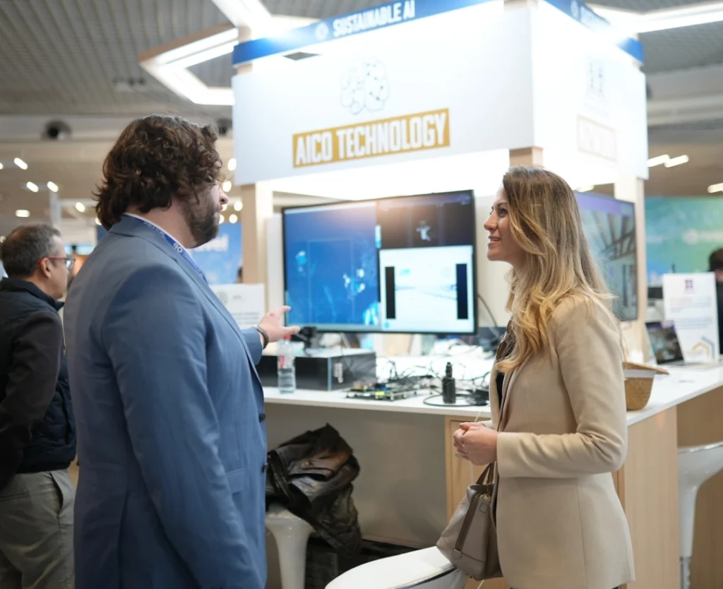 AnchorzUp's CEO Jeta Zagragja at WAICF 2025 in across AICO Technology booth