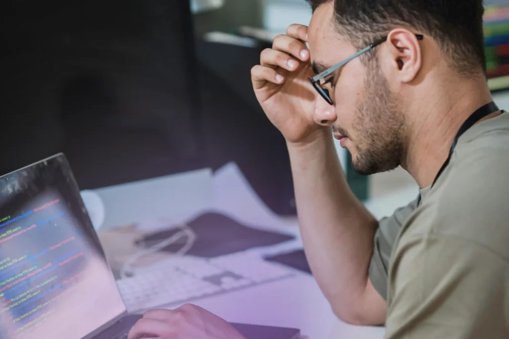 Software engineer focused on writing code on a laptop, representing platform engineering and developer productivity