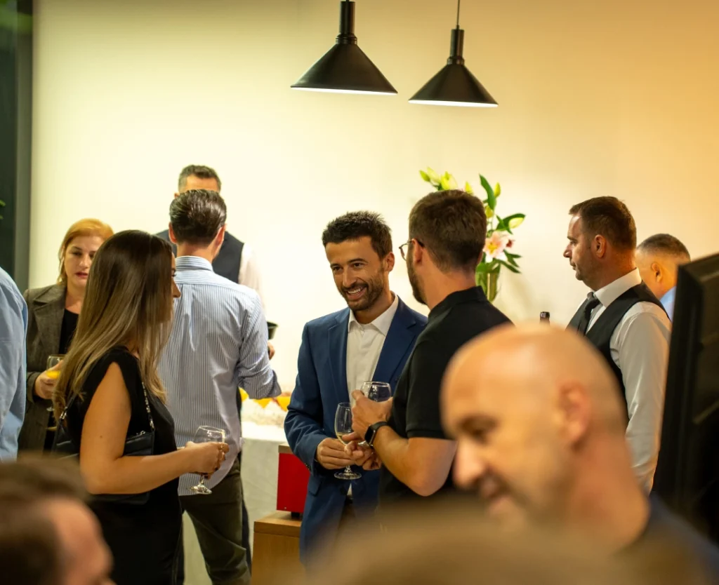 Lum Zagragja smiling and interacting with guests at AnchorzUp grand opening event