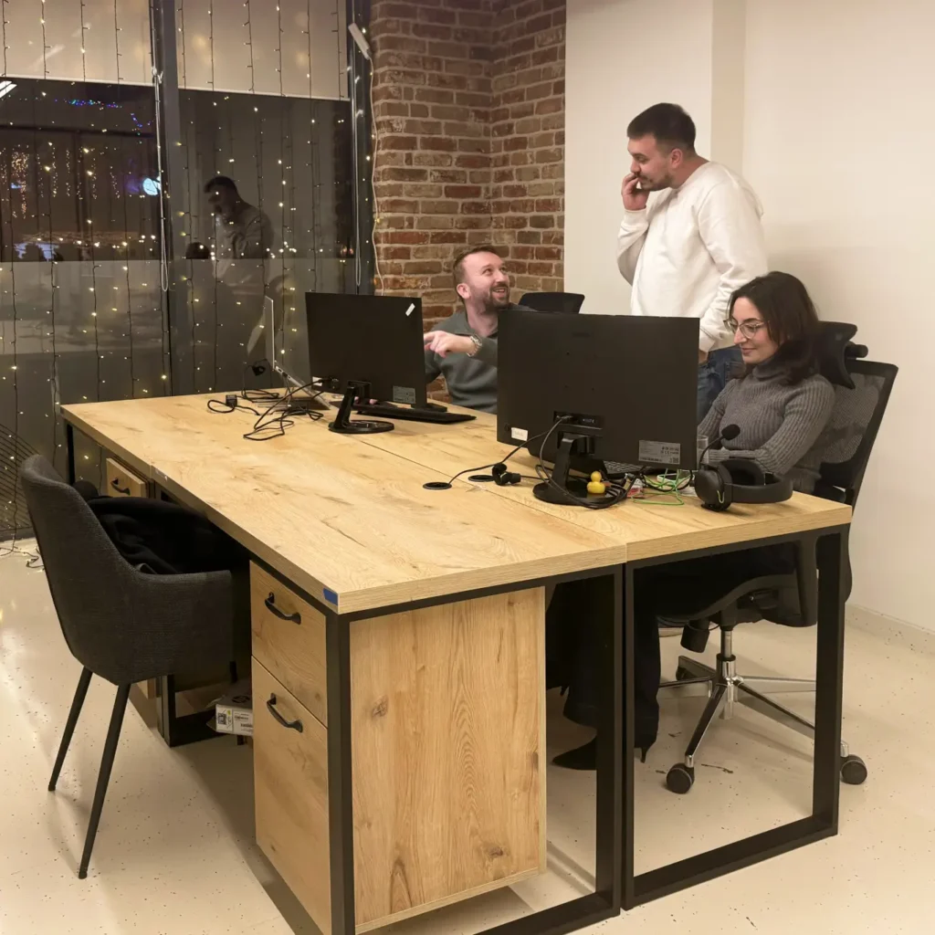 AnchorzUp's software development team happily discussing a successful launch